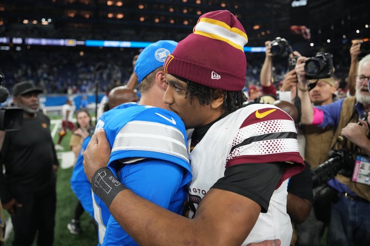 DETROIT, MICHIGAN - JANUARY 18: Jared Goff #16 of the Detroit Lions greets Jayden Daniels #5 of the Washington Commanders following the NFC Divisional Playoff at Ford Field on January 18, 2025 in Detroit, Michigan. Washington defeated Detroit 45-31. (Photo by Nic Antaya/Getty Images)