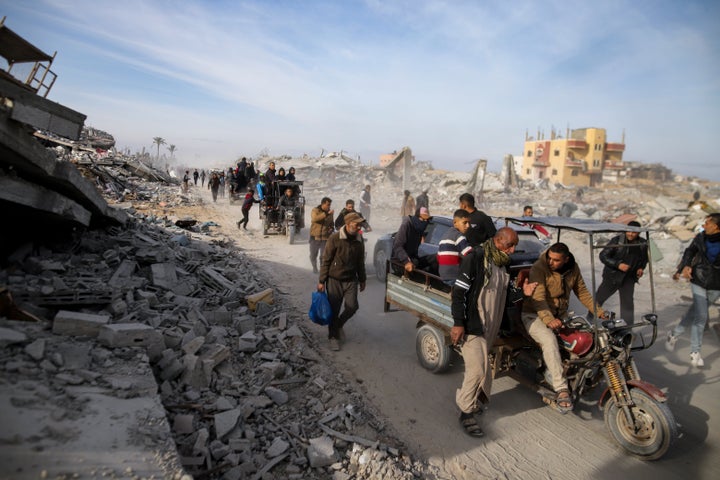 Displaced Palestinians leave parts of Khan Younis as they go back to their homes in Rafah, southern Gaza Strip, on Sunday, Jan. 19, 2025.