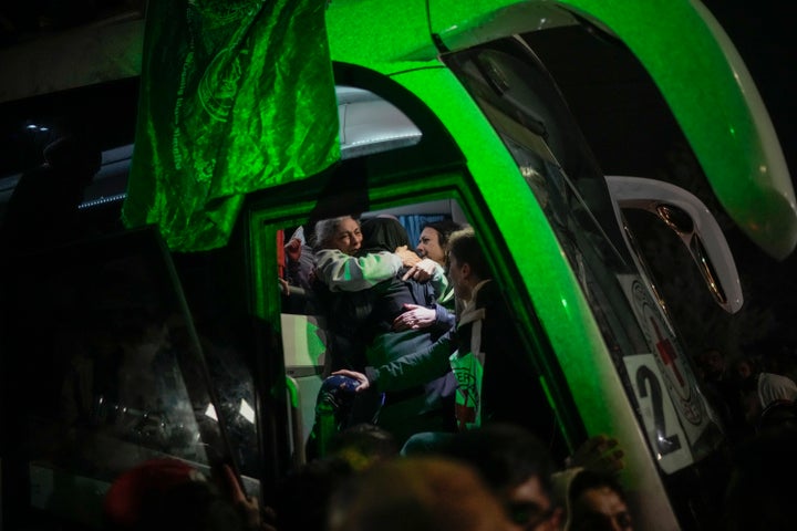 A Palestinian prisoner is greeted before she disembarks from a bus after being released from an Israeli prison, in the West Bank city of Beitunia, early Monday, Jan. 20, 2025. (AP Photo/Leo Correa)