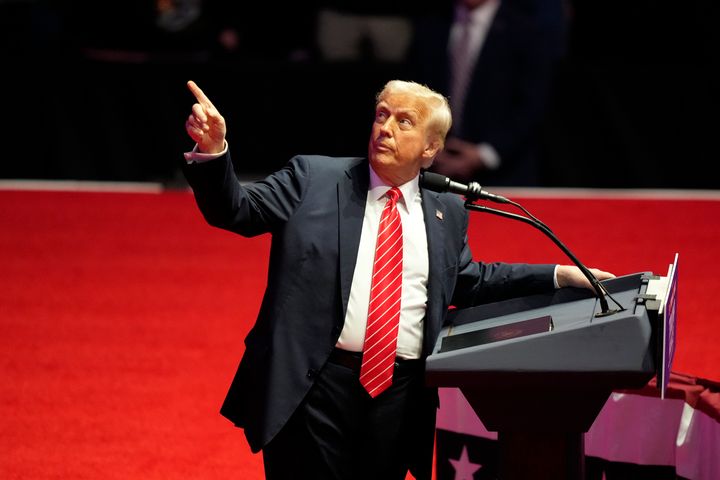 President-elect Donald Trump points to a chart on screen as he speaks at a rally ahead of the 60th Presidential Inauguration, Sunday, Jan. 19, 2025.