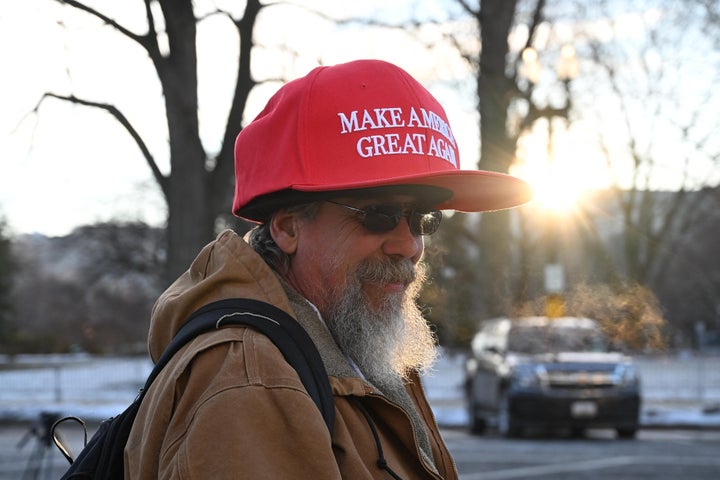 A man wears an aggressively oversized "Make America Great Again" hat near the U.S. Capitol on Inauguration Day.