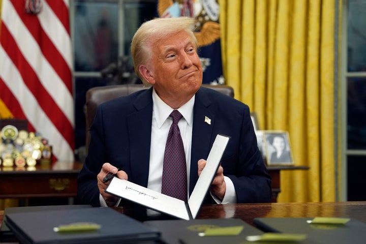 President Donald Trump signs executive orders in the Oval Office on Monday.