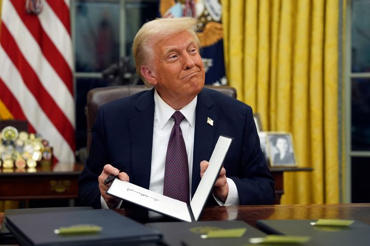 President Donald Trump signs executive orders in the Oval Office on Monday.