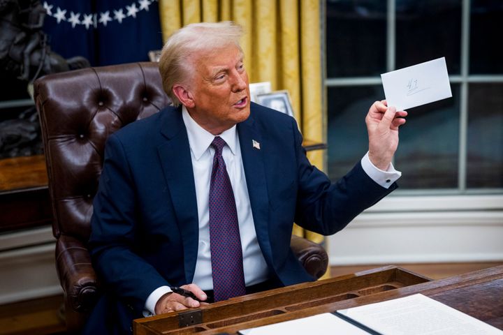 Trump looks at a letter left for him by former President Joe Biden.