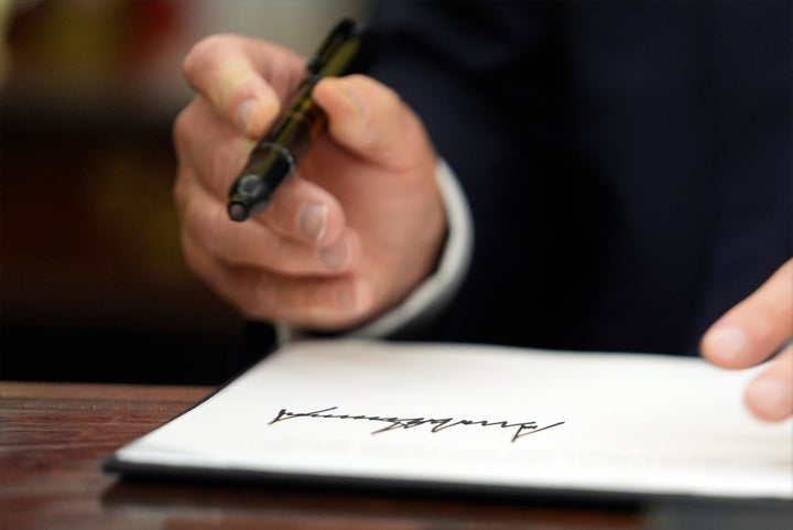 President Donald Trump signs executive orders in the Oval Office of the White House, Monday, Jan. 20, 2025, in Washington. (AP Photo/Evan Vucci)