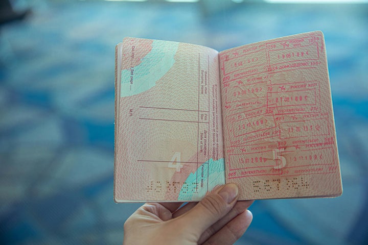 Person holding an open passport.