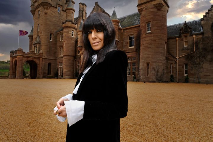 Claudia Winkleman in front of the famous Traitors castle.