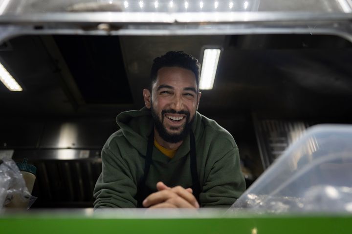 Daniel Shemtob smiles as he looks out from the service window of his food truck, The Lime Truck, as he serves burritos to Eaton Fire first responders at the Rose Bowl Stadium in Pasadena, California, last week.