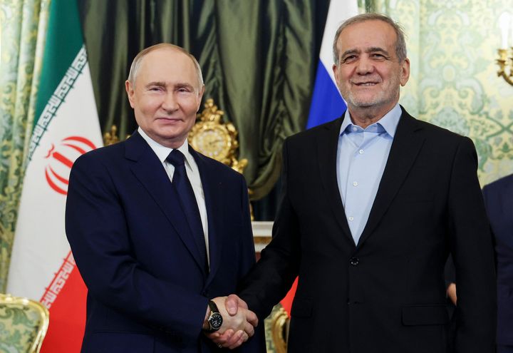 Russian President Vladimir Putin, left, and Iranian President Masoud Pezeshkian pose for a photo during their meeting at the Kremlin in Moscow, Russia, Friday, Jan. 17, 2025. 