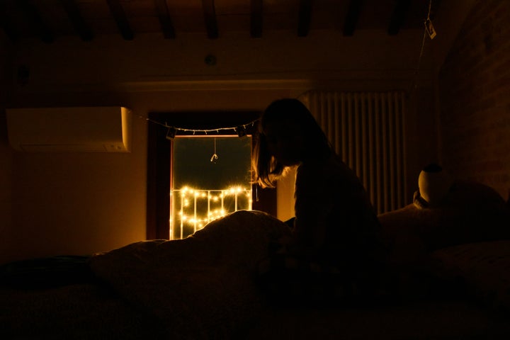 Young woman awake in a dark room