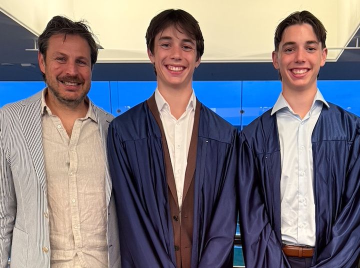 The author poses with his sons at their high school graduation.