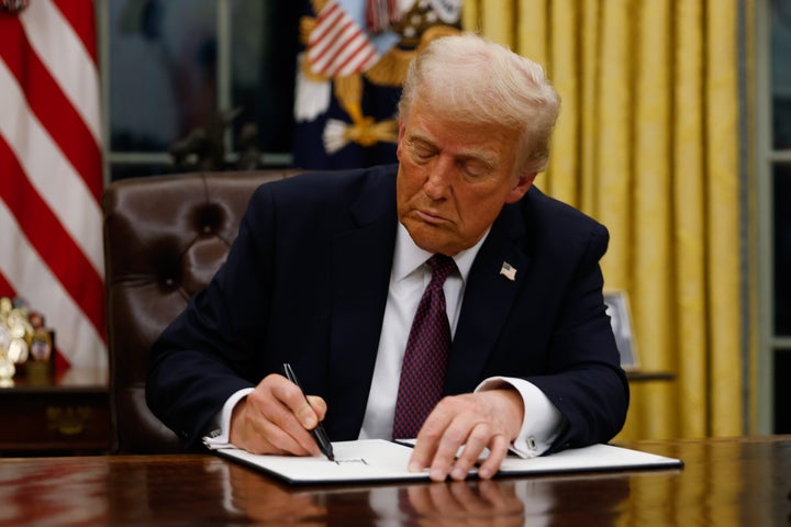 President Donald Trump signs executive orders in the Oval Office of the White House on Jan. 20 in Washington, D.C.