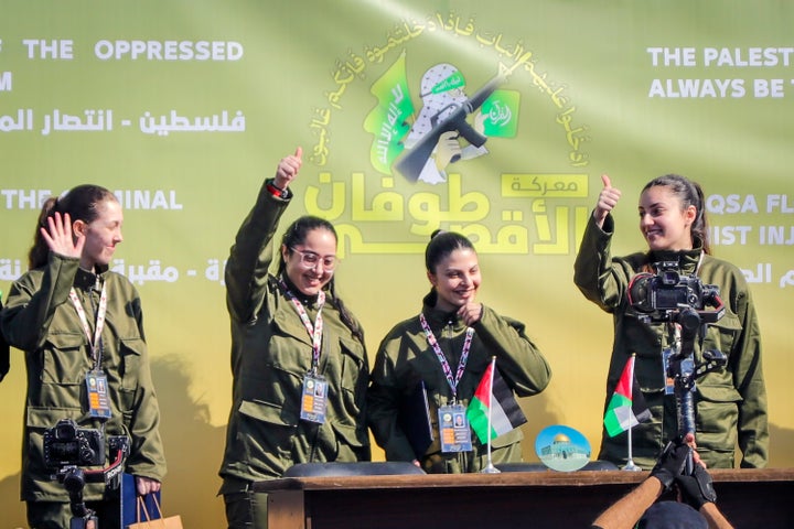 Israeli soldier hostages Naama Levy, Daniella Gilboa, Karina Ariev and Liri Albag, in no particular order, salute a Palestinian crowd before being handed over to the Red Cross in Gaza City, Saturday, Jan. 25, 2025. (AP Photo/Abed Hajjar)