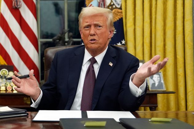 President Donald Trump talks to reporters as he signs executive orders in the Oval Office of the White House, Monday, Jan. 20, 2025, in Washington.