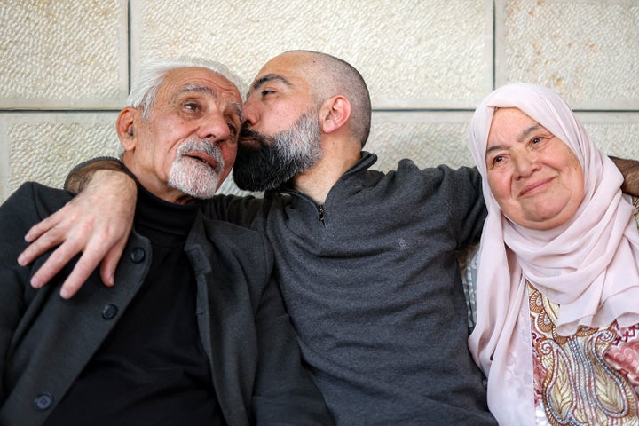 Ashraf al-Zagheer, a recently released 46-year-old Palestinian who spent 23 years in Israeli prison serving six life sentences, kisses his father at their family home in the occupied West Bank's Kafr Aqab, on Jan. 26, 2025. Al-Zagheer's release was part of the Jan. 25 hostage-prisoner swap under the ceasefire deal between Israel and Palestinian militants like Hamas.