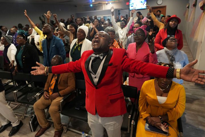 Jean-Michel Gisnel cries out while praying with other congregants at the First Haitian Evangelical Church of Springfield on Sunday.