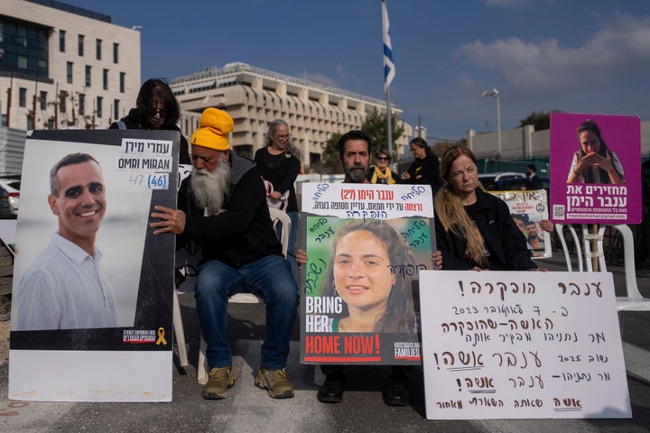 Families and supporters of Israeli hostages held in Gaza by Hamas, hold photos of their loved ones during a protest for their release outside the prime minister's office in Jerusalem, on Sunday, Jan. 26, 2025.