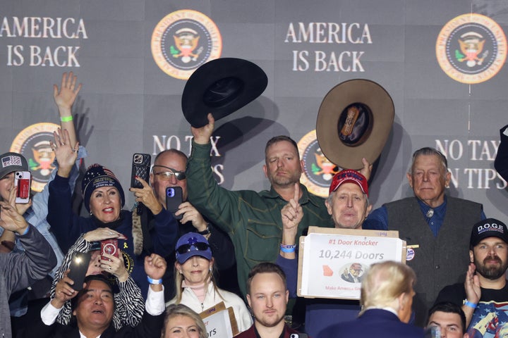 Stewart Rhodes (eye patch), Ryan Bundy (green shirt) and Cliven Bundy (gray vest) react Saturday after President Donald Trump spoke at a rally at Circa Resort & Casino in Las Vegas. The event focused on Trump’s first week in office.