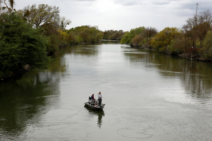 People fish in the Sacramento-San Joaquin River Delta's Elk Slough near Courtland, California, on March 24, 2020. 