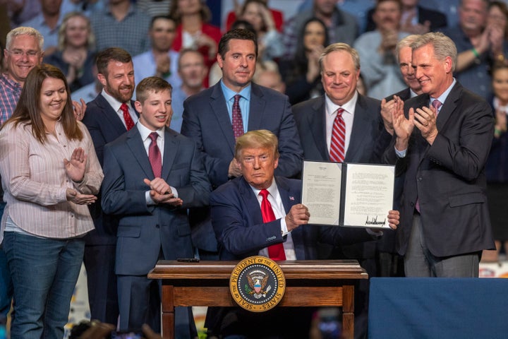 President Donald Trump ceremonially signs legislation at a rally with local farmers on Feb. 19, 2020, in Bakersfield, California. The presidential signing ushers in his administration's new rules altering how federal authorities decide who gets water and how much in California, sending more water to farmers despite predictions that the changes will further threaten endangered species in the fragile San Joaquin Delta.