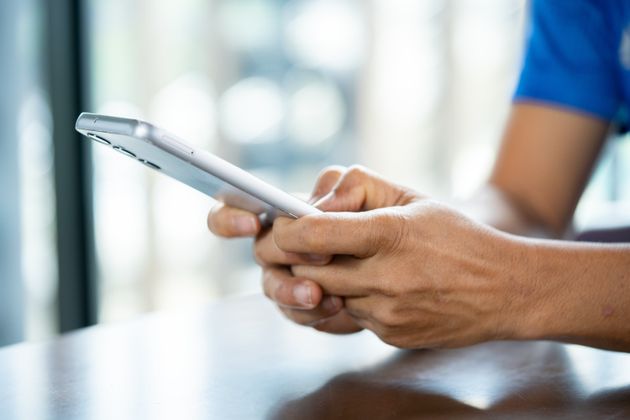 Close up of a man using mobile smart phone.