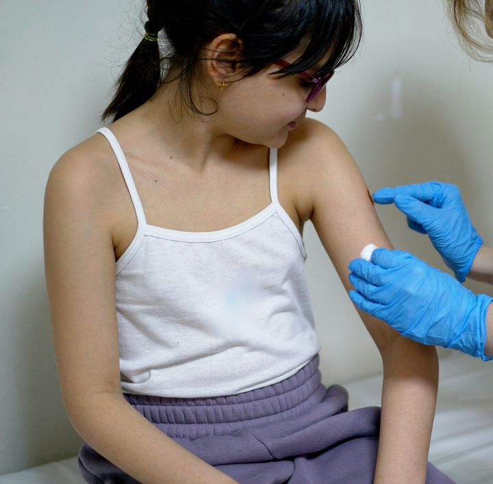 little girl getting tetanus shot