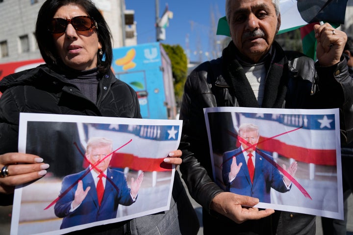 Palestinians in the occupied West Bank city of Ramallah carry defaced pictures of U.S. President Donald Trump while protesting his latest statement suggesting Egypt and Jordan take in Palestinians from Gaza, on Wednesday, Jan. 29, 2025.