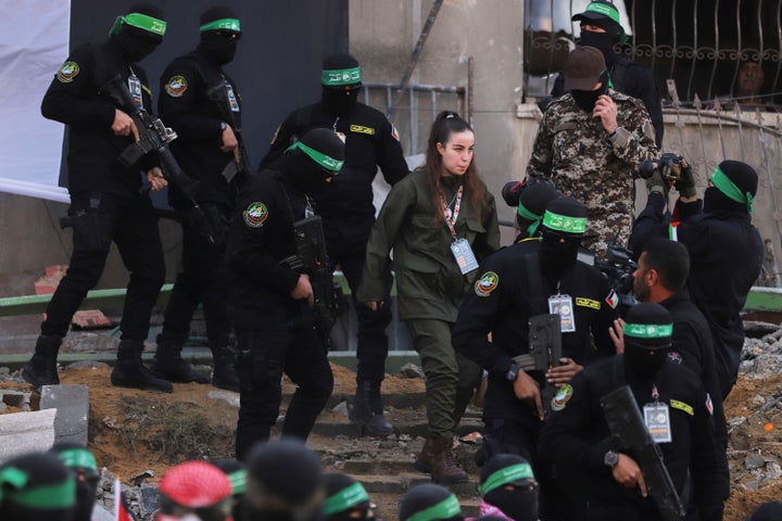 Israeli soldier Agam Berger walks next to masked Islamic Jihad militants as she is handed over to the Red Cross at the Jabalya refugee camp in Gaza City, on Jan. 30, 2025.