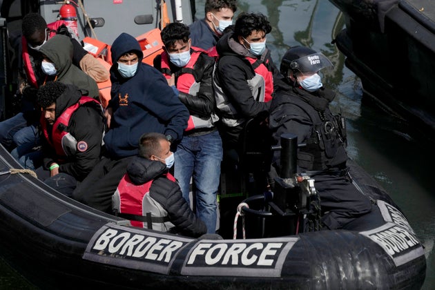 Migrants who undertook the crossing from France in small boats and were picked up in the Channel, arrive to be disembarked from a small transfer boat.