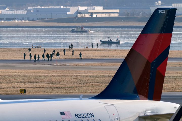 Search and rescue efforts are seen around a wreckage site in the Potomac River from Ronald Reagan Washington National Airport, early Thursday morning, Jan. 30, 2025, in Arlington, Va. (AP Photo/Mark Schiefelbein)