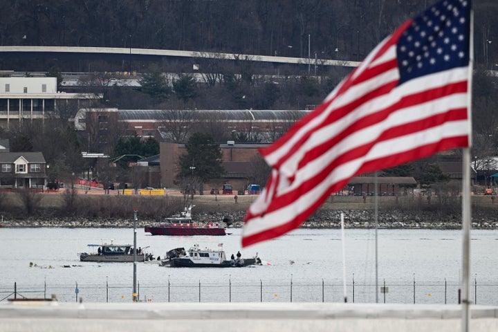 A police boat gathers wreckage along the Potomac River after American Airlines flight 5342 on approach to Reagan National Airport crashed into the river after colliding with a US Army helicopter, near Washington, DC, on January 30, 2025. (Photo by OLIVER CONTRERAS/AFP via Getty Images)