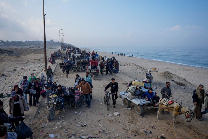 Displaced Palestinians walk on a road in central Gaza to return to their homes in the northern Gaza Strip, following the Israel-Hamas ceasefire deal, Friday, Jan. 31, 2025. (AP Photo/Abdel Kareem Hana)