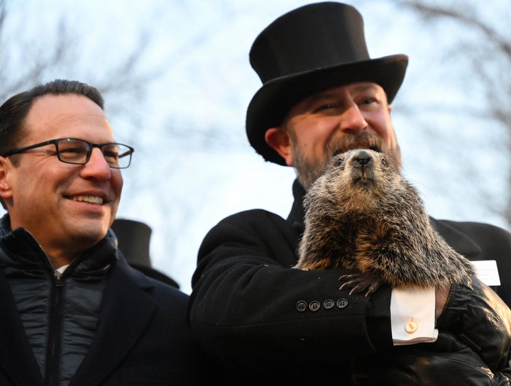 Groundhog Club handler A.J. Dereume holds Punxsutawney Phil as Shapiro looks on in 2023.