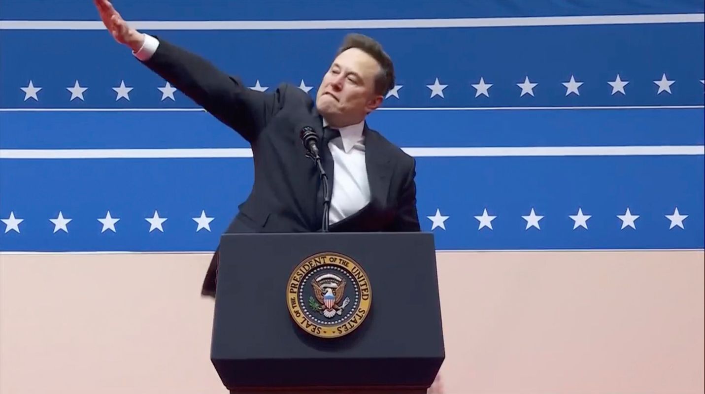 Elon Musk gestures while speaking at an indoor Presidential Inauguration parade event in Washington, Monday, Jan. 20, 2025. (AP Photo)