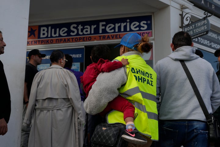 People wait to buy boat and air tickets as Greek authorities are taking emergency measures in response to intense seismic activity on the popular Aegean Sea holiday island of Santorini, southern Greece, on Feb. 3, 2025.