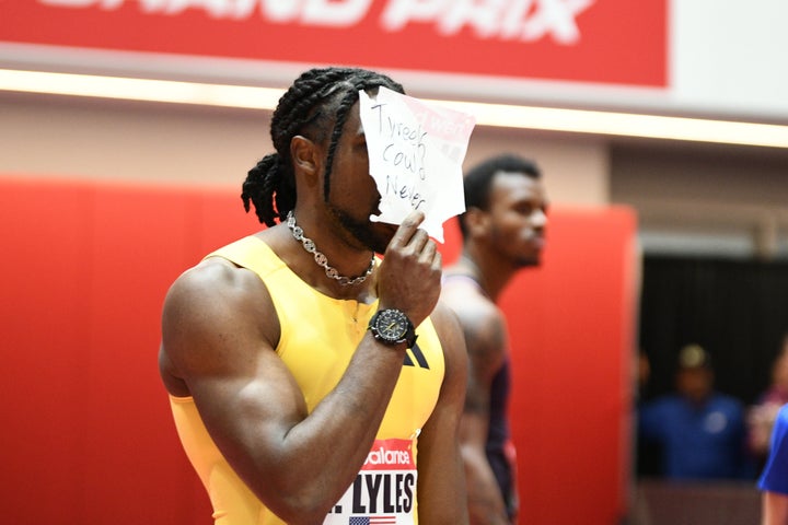 Noah Lyles holds a sign reading "Tyreek could never" after winning the men's 60m in the New Balance Indoor Grand Prix on Feb. 2 in Boston.