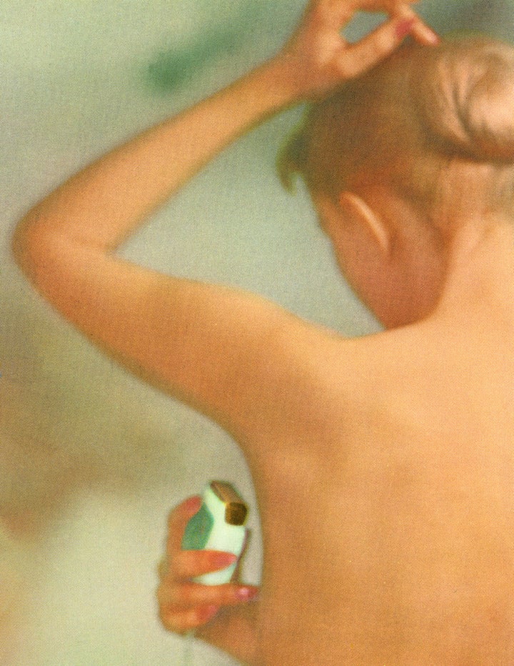 A 1958 screen print of a photograph showing a woman in the shower using a retro electric shaver on her underarms.