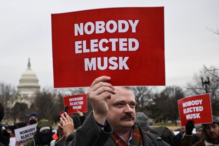 People protest against President Donald Trump and Elon Musk's nonofficial Department of Government Efficiency on Wednesday near the U.S. Capitol.