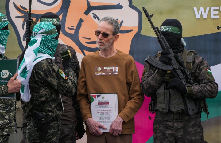 Ohad Ben Ami, an Israeli who has been held hostage by Hamas in Gaza since Oct. 7, 2023, is escorted by fighters before getting handed over to the Red Cross in Deir al-Balah, central Gaza Strip, on Saturday Feb. 8, 2025.