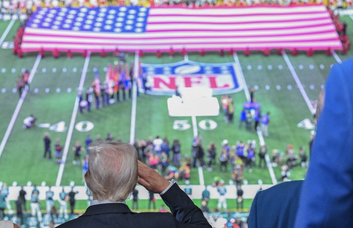 US President Donald Trump salutes as the national anthem is played at Super Bowl LIX.