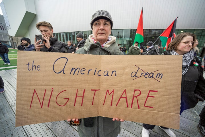 A protester holds a banner during the demonstration against U.S. President Donald Trump, in Rotterdam, Netherlands, on Feb. 8. Palestinians and their supporters protested Trump's remarks about taking control over Gaza.