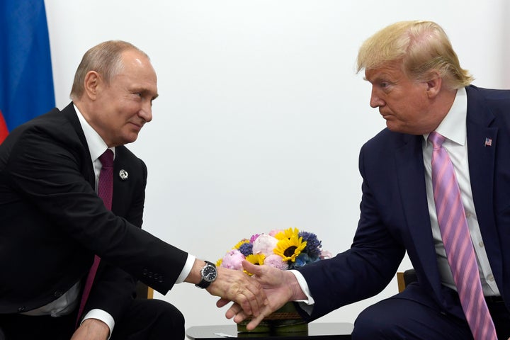 Donald Trump shakes hands with Vladimir Putin at the G20 summit in 2019.