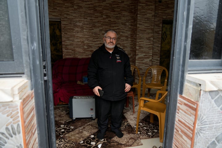 Mohammed Shula poses for a photo inside a relative's house, where he and his wife have taken refuge at the West Bank village of Kafr al-Labad, on Monday, Feb. 10, 2025.