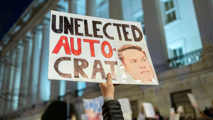 People protest during a rally against Elon Musk outside the Treasury Department in Washington, Tuesday, Feb. 4, 2025. (AP Photo/Jose Luis Magana)