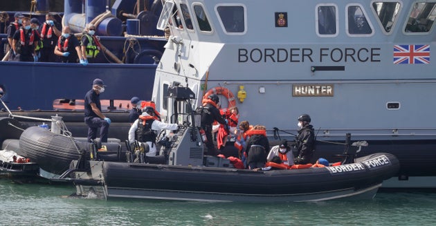 A Border Force vessel brings a group of people thought to be migrants into Dover.
