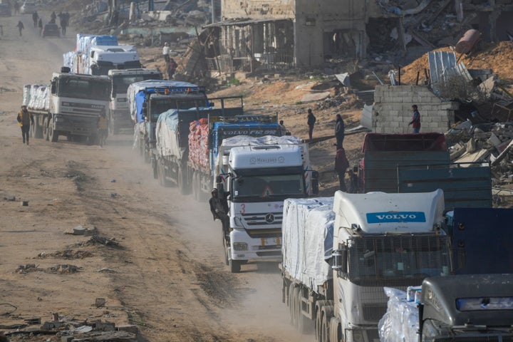 Trucks carrying humanitarian aid enter the Gaza Strip from Egypt in the southern town of Rafah, on Wednesday, Feb. 12, 2025.