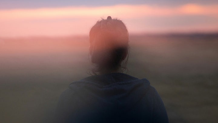 Woman looking dizzy in morning light