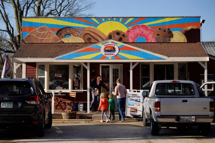 A customer holds the door for a family arriving at Leavitt's Country Bakery in this April 13, 2023 file photo, in Conway, New Hampshire.