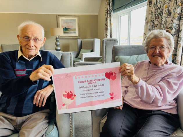 Jeff (96) and Madge (94) holding a sheet which contains Madge's dating advice