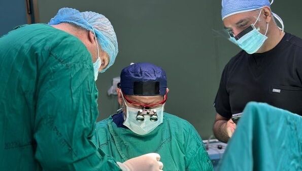 Dr. Adam Hamawy and his colleagues perform a surgical operation on a patient while volunteering at Nasser Hospital in Gaza, following the Israel-Hamas ceasefire.